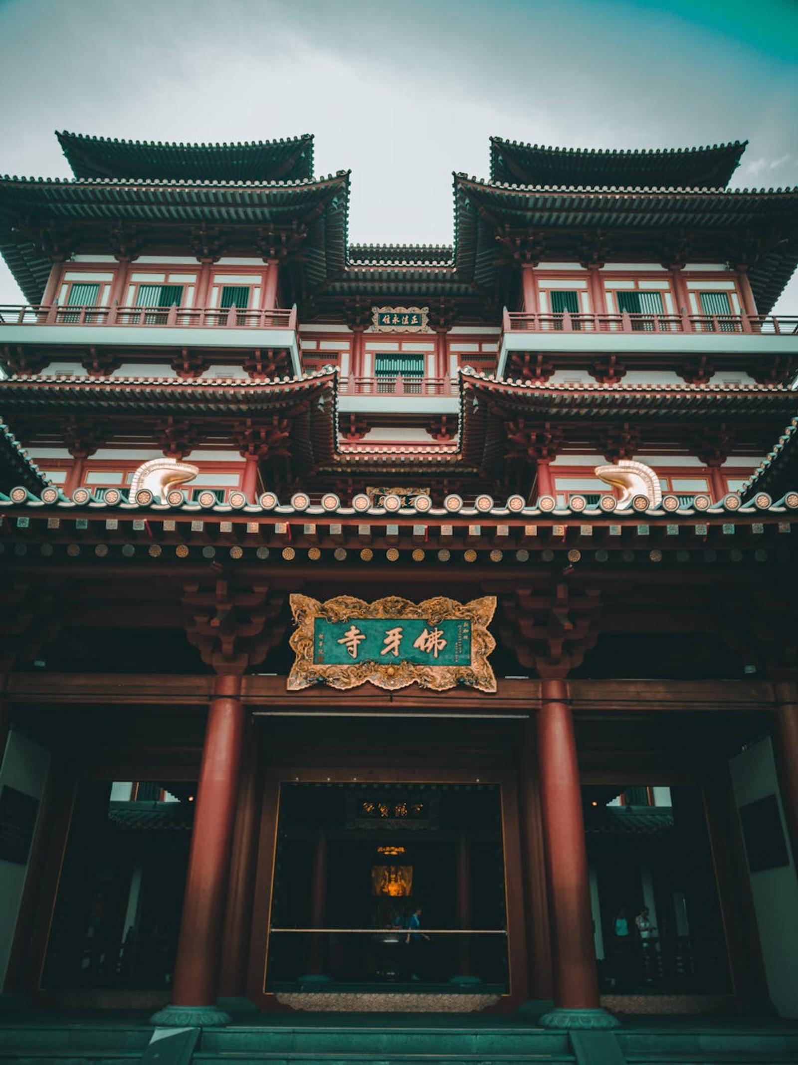Ornate red and gold multi-tiered temple facade with carved eaves