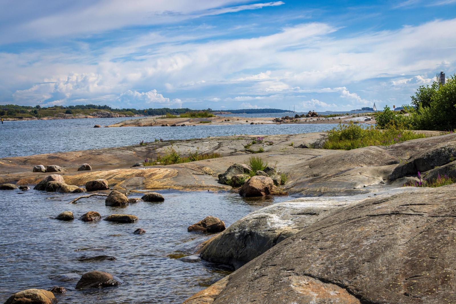 Tranquil view of rocky coastline and sea in Helsinki on a sunny day