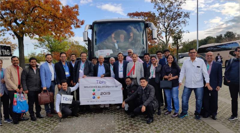 Group photo with Tabro banner in front of a tour bus, 2019.