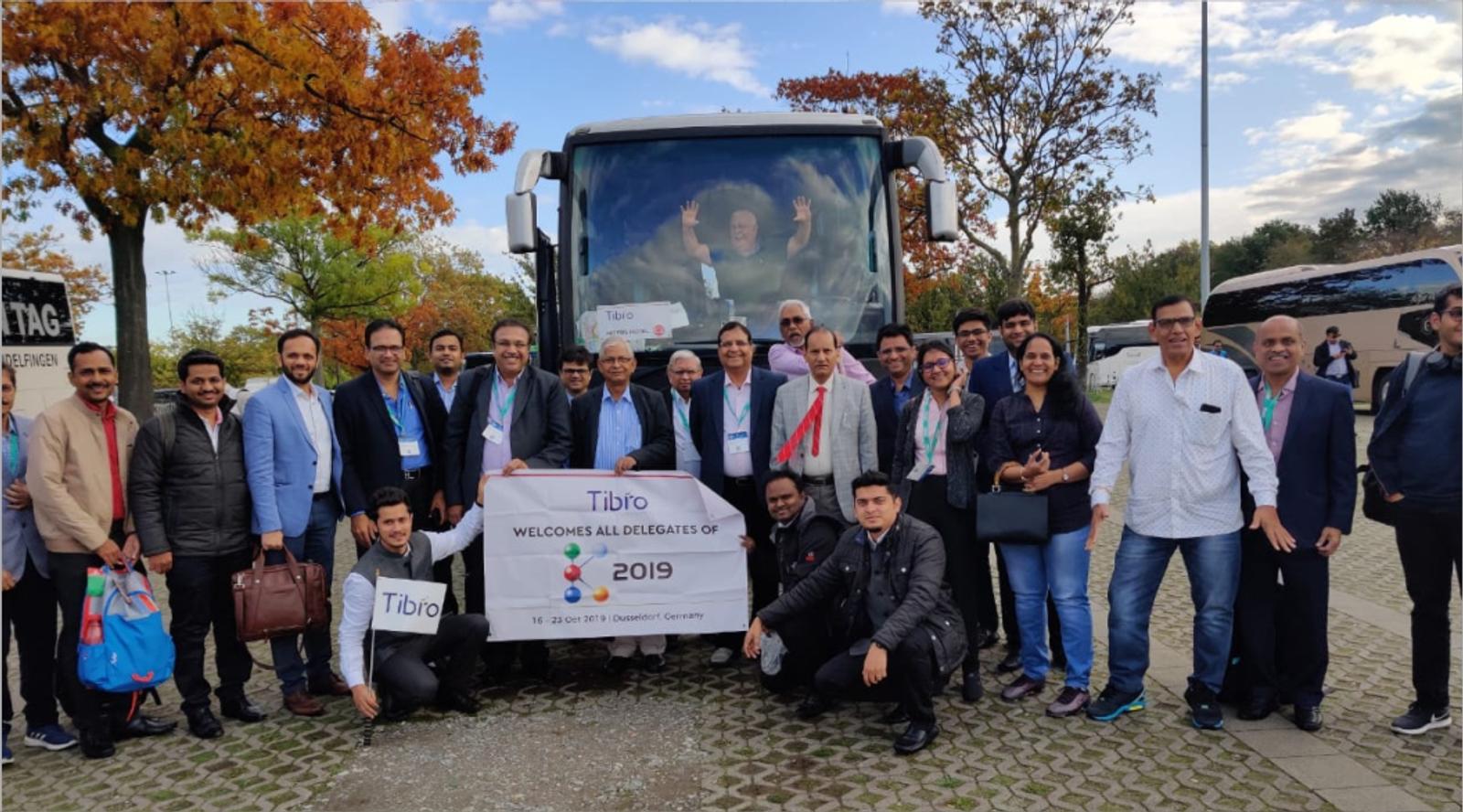 Group photo with Tabro banner in front of a tour bus, 2019.