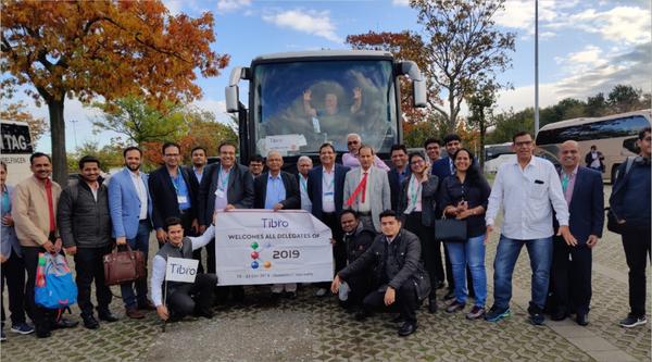 Group photo with Tabro banner in front of a tour bus, 2019.