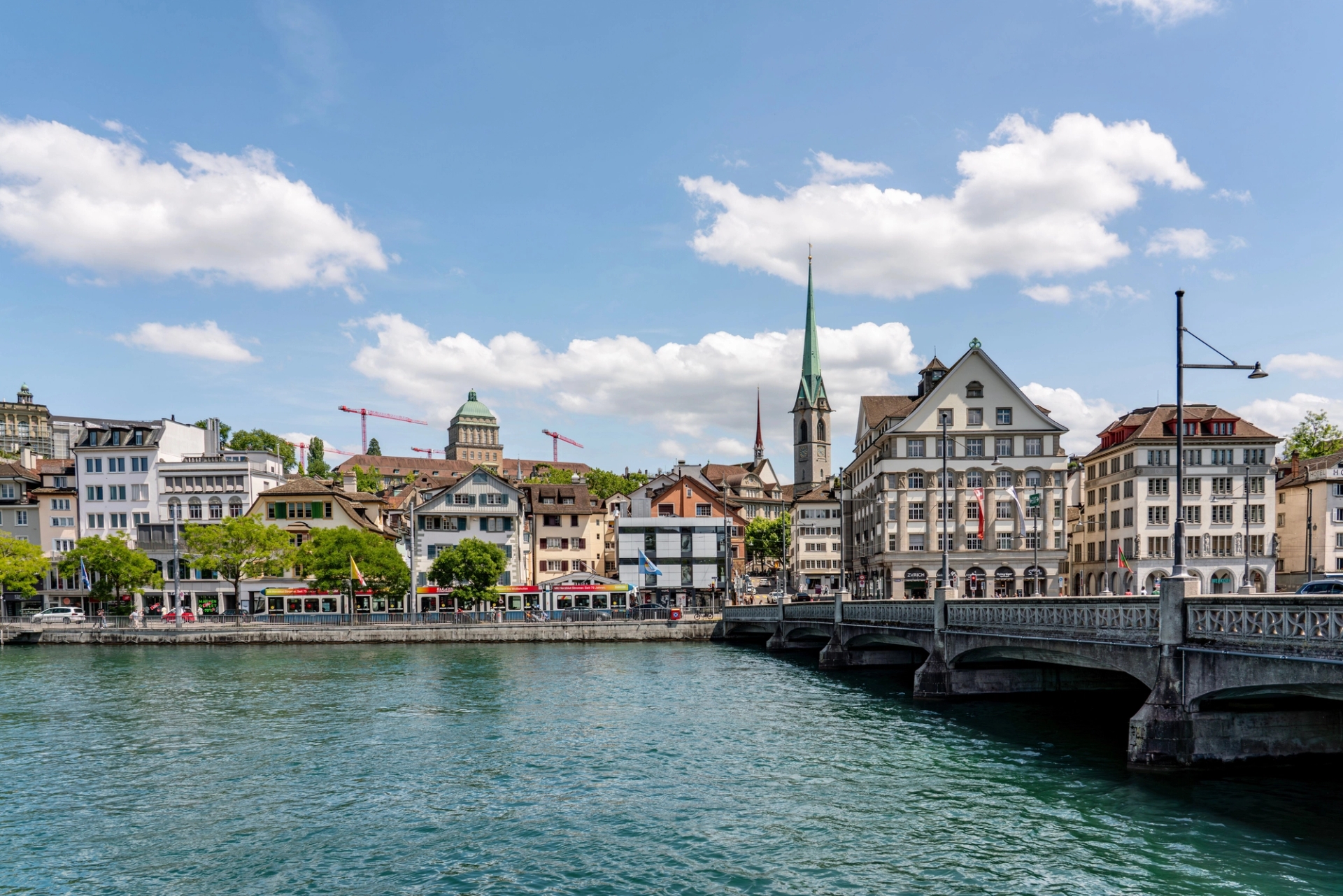 Charming view of Zurich with historic buildings along the Limmat River under a clear blue sky