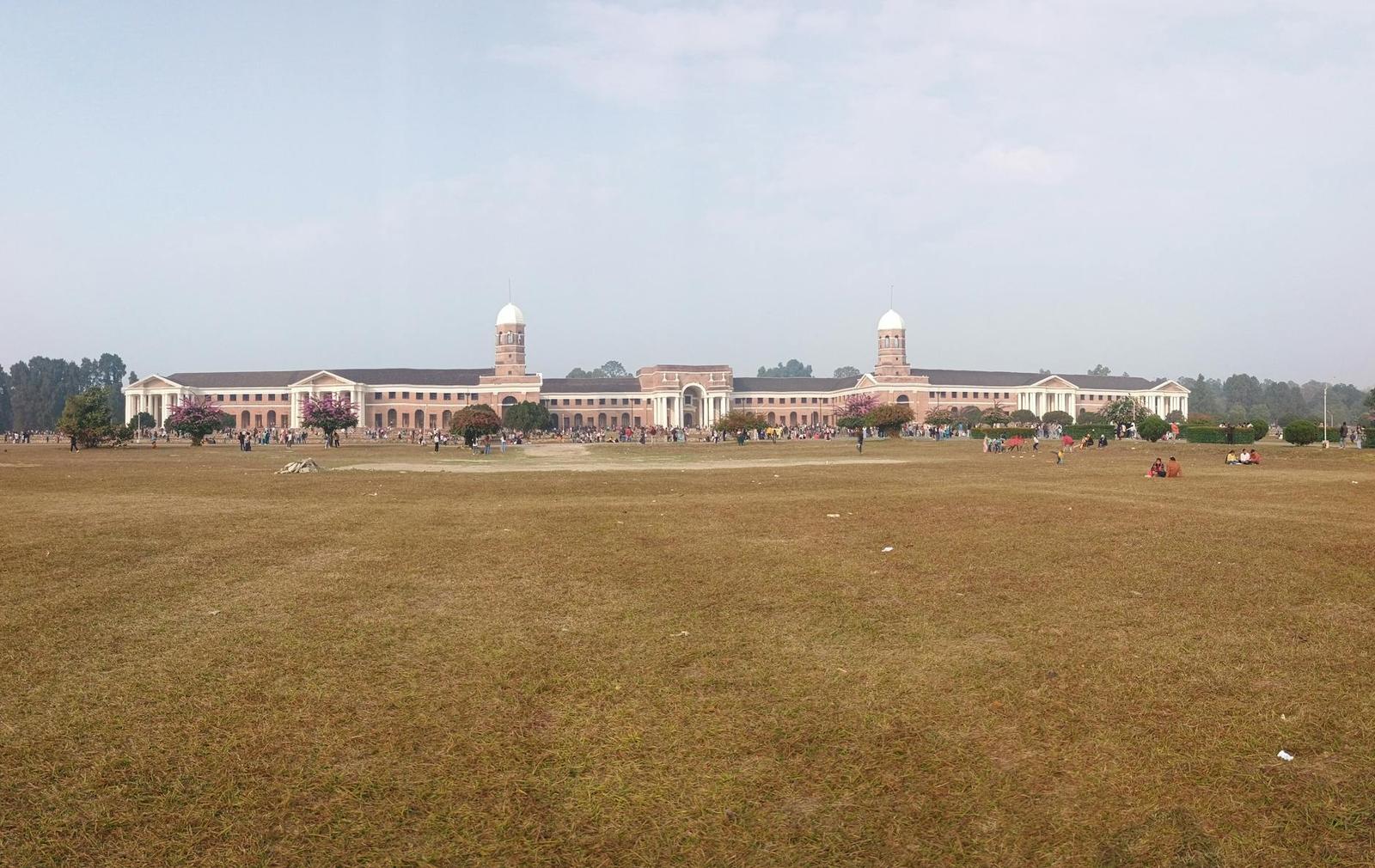 The grand facade of the Forest Research Institute in Dehradun, India, set against a clear sky
