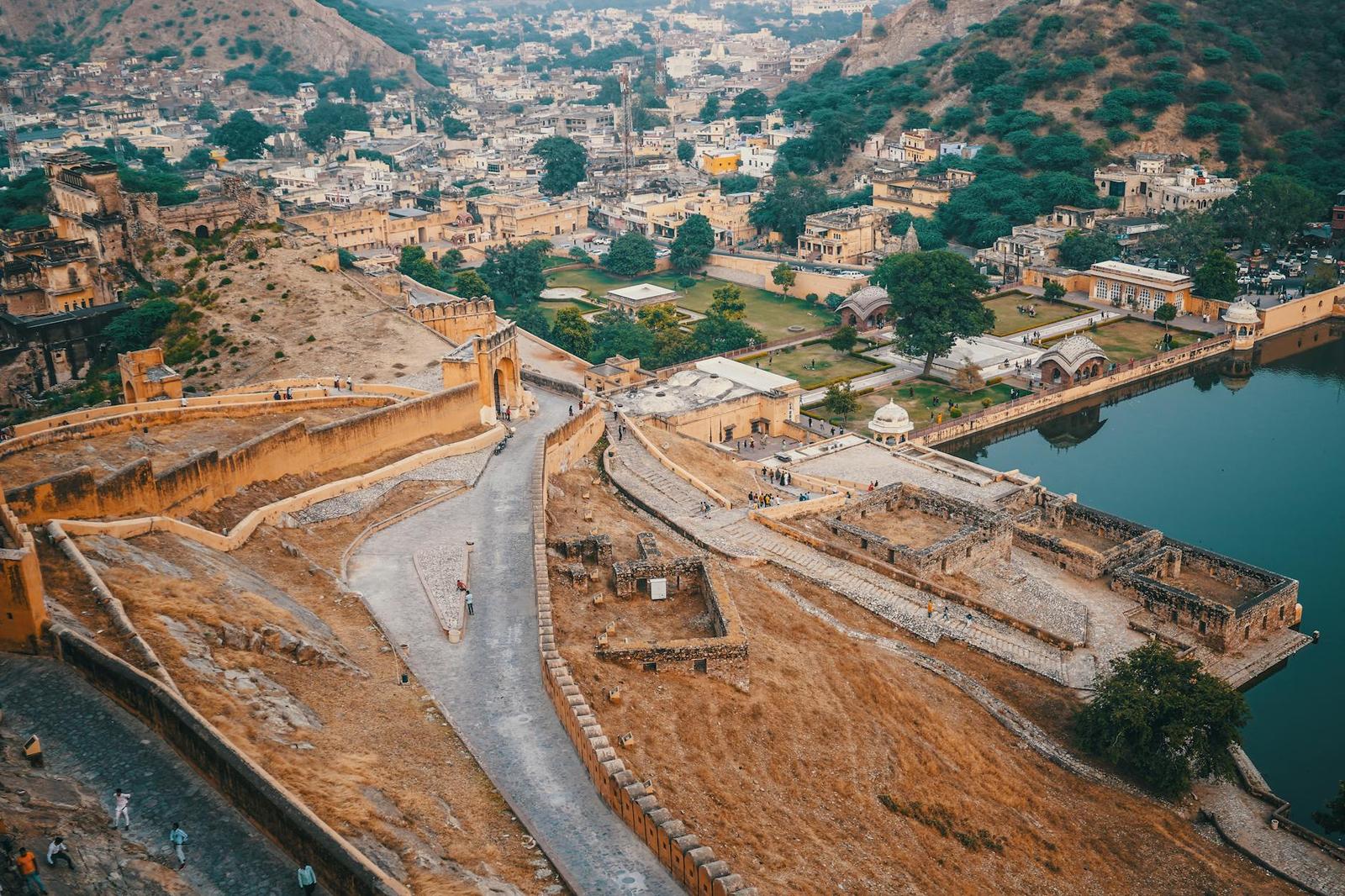 An aerial view of fort ramparts winding above a town beside a lake