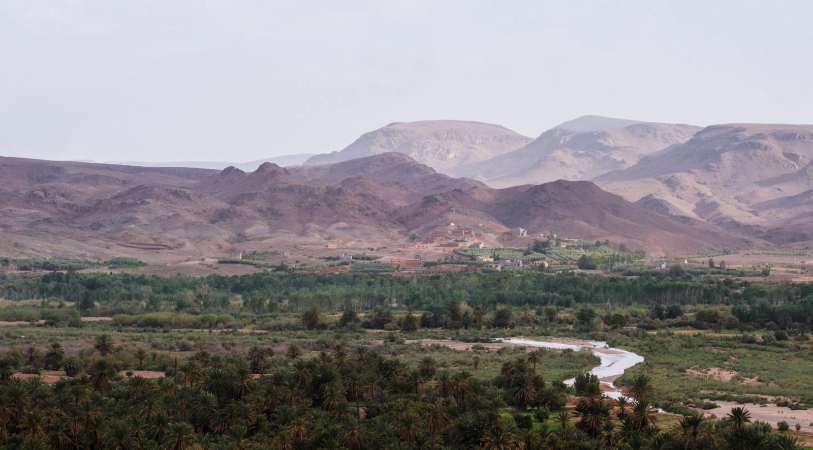 Expansive view of the Atlas Mountains and lush valleys in Morocco, showcasing natural beauty