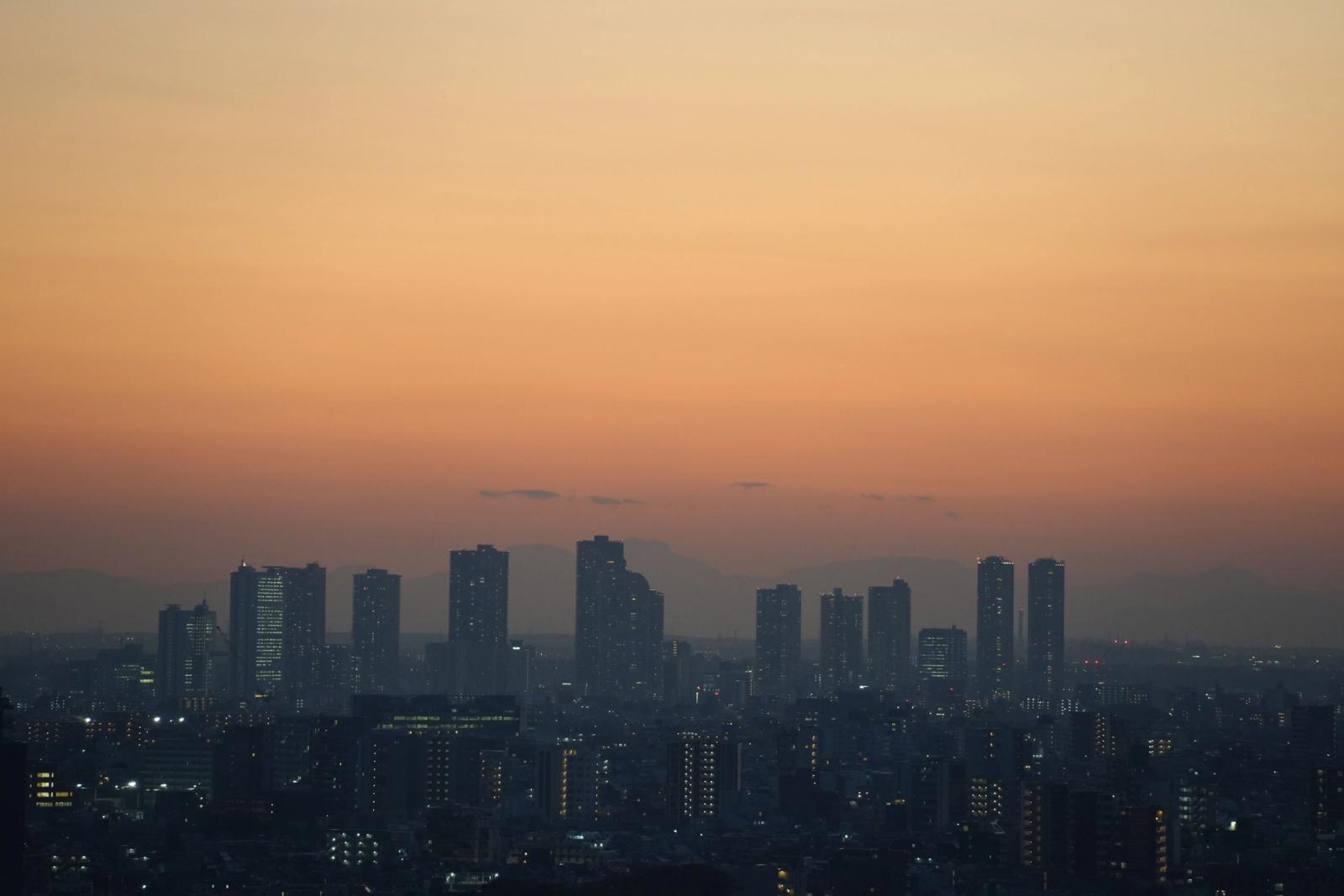 Stunning view of Tokyo skyscrapers silhouetted against a vibrant sunset sky at dusk