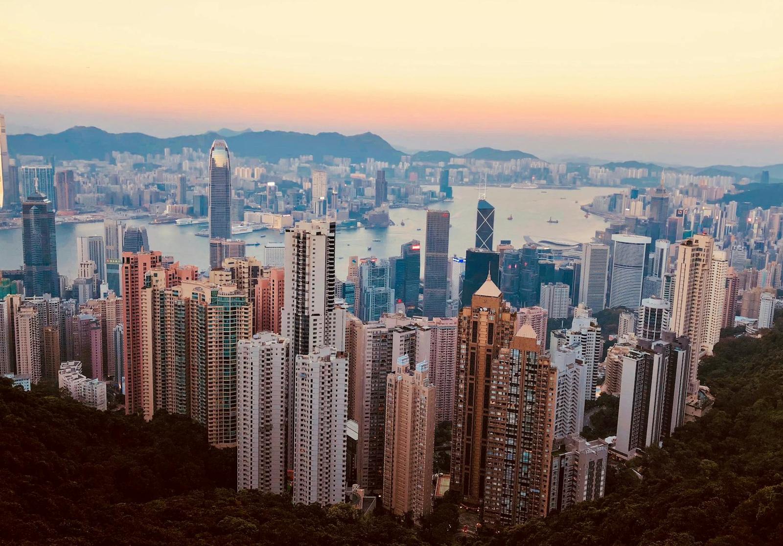 Breathtaking Kowloon skyline with skyscrapers and harbor at sunset