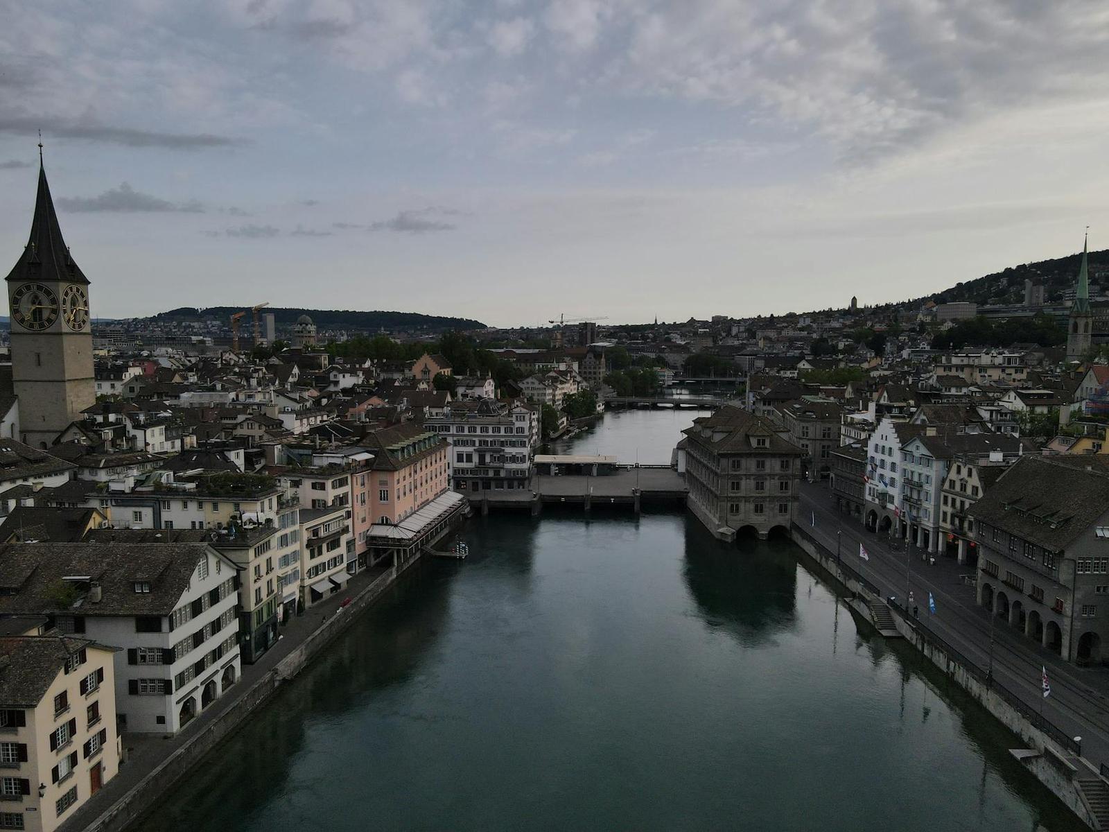 Aerial view of a river winding through a historic old town with a church spire