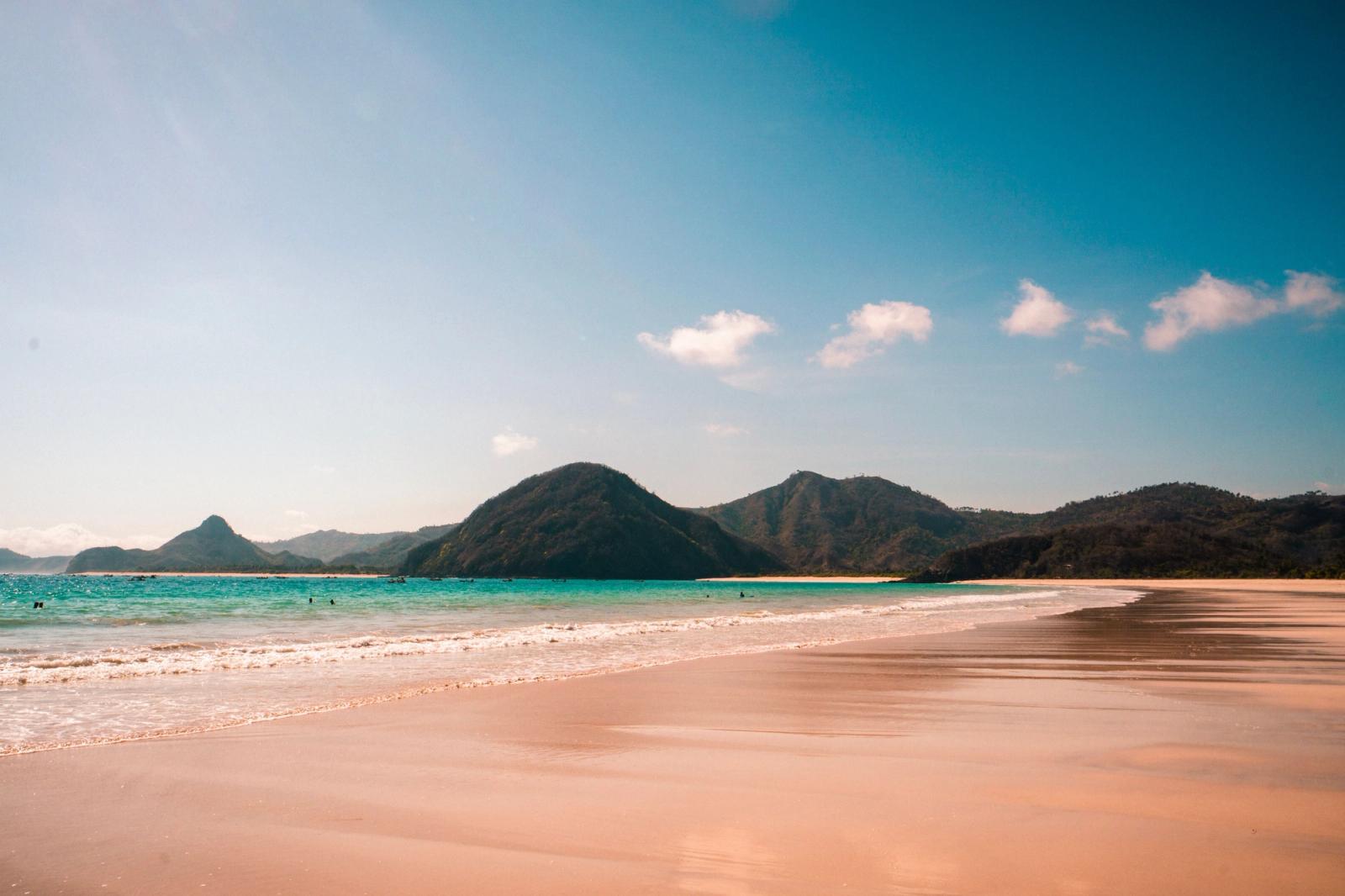 A tranquil beach view with mountains and turquoise water in West Nusa Tenggara, Indonesia