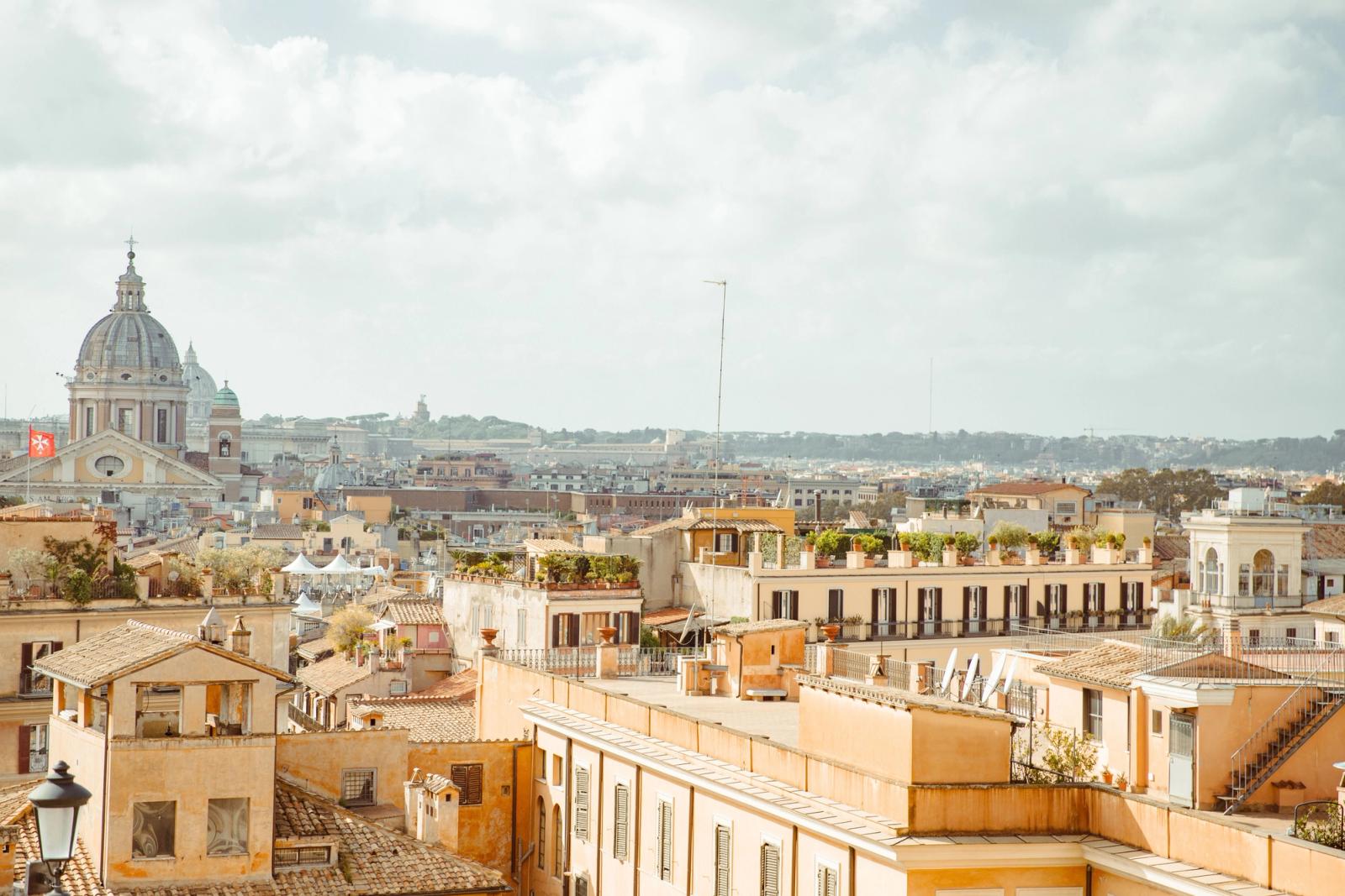 Panoramic view of Rome's historic rooftops highlighting classic Italian architecture and St. Peter's Basilica