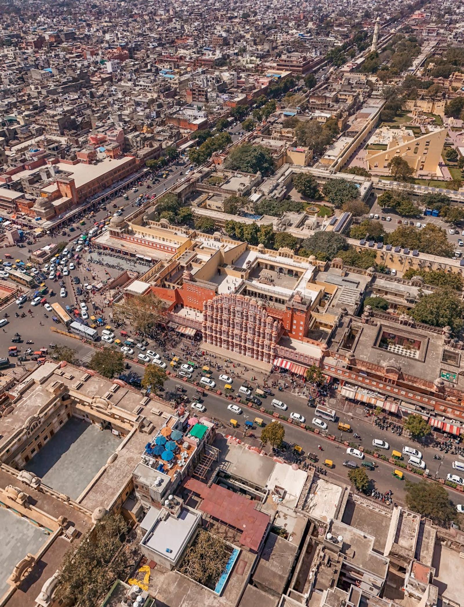Aerial view of a dense old city with a honeycomb-fronted palace facade