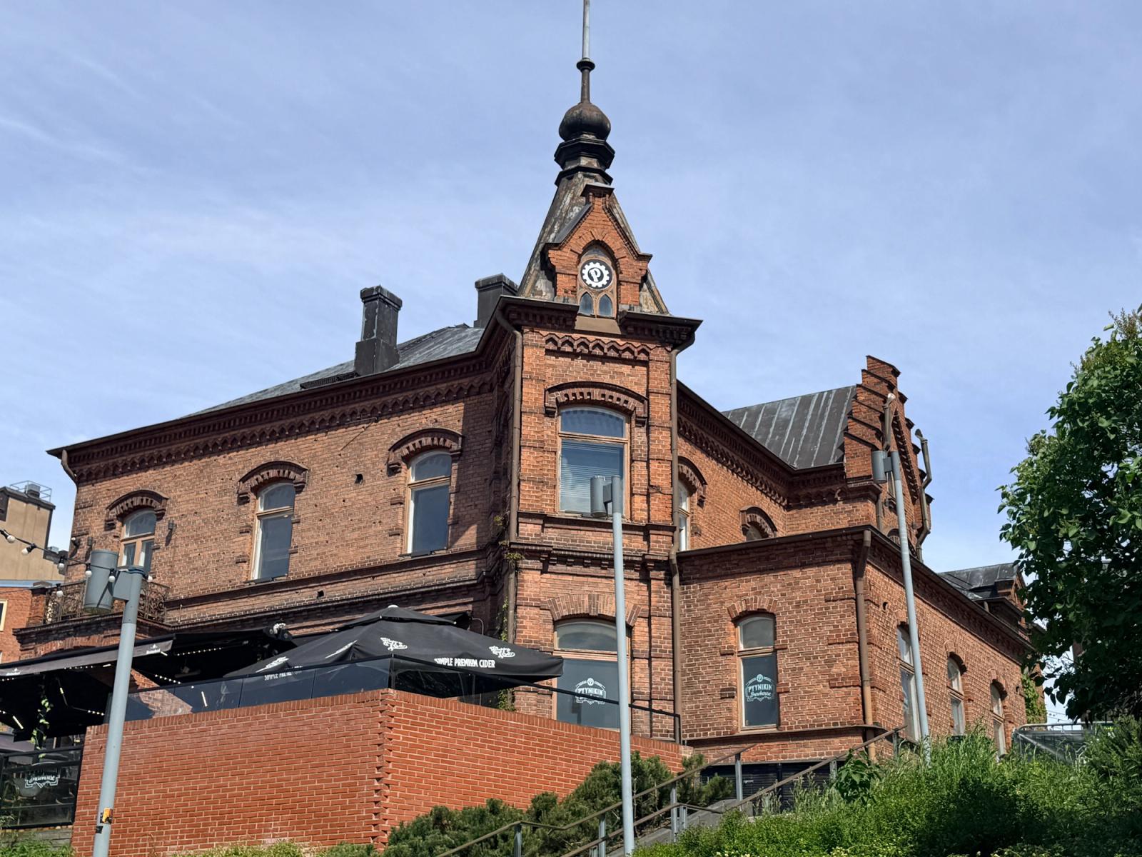Capture of a classic red brick building in Tampere, Finland, under a clear sky