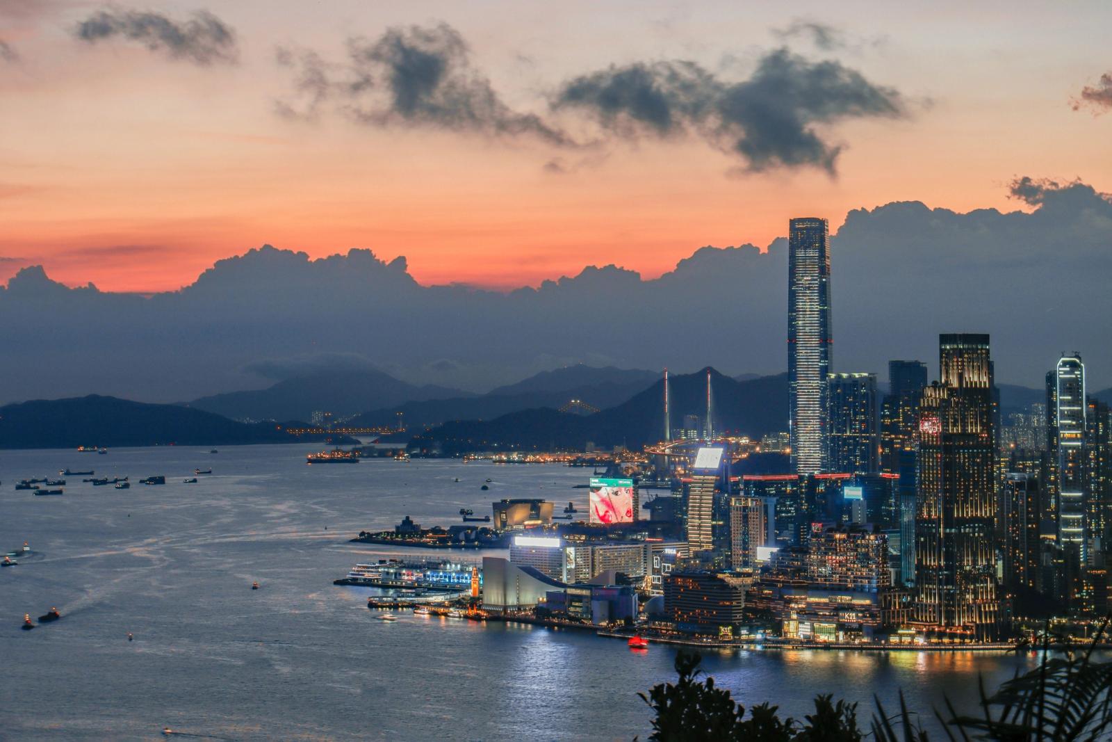 Stunning view of Hong Kong Island skyline with vibrant sunset colors over Victoria Harbour