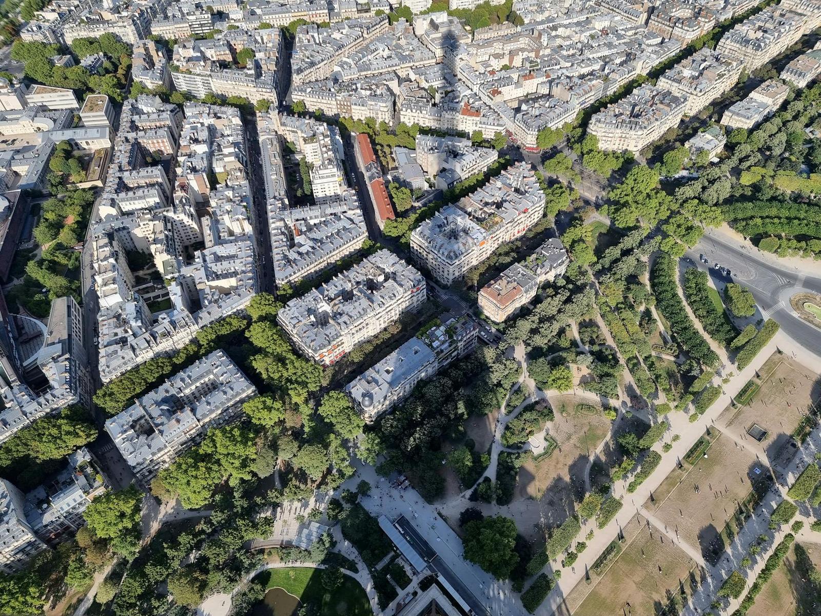 A stunning aerial view of Paris showcasing classic architecture and iconic shadows of the Eiffel Tower