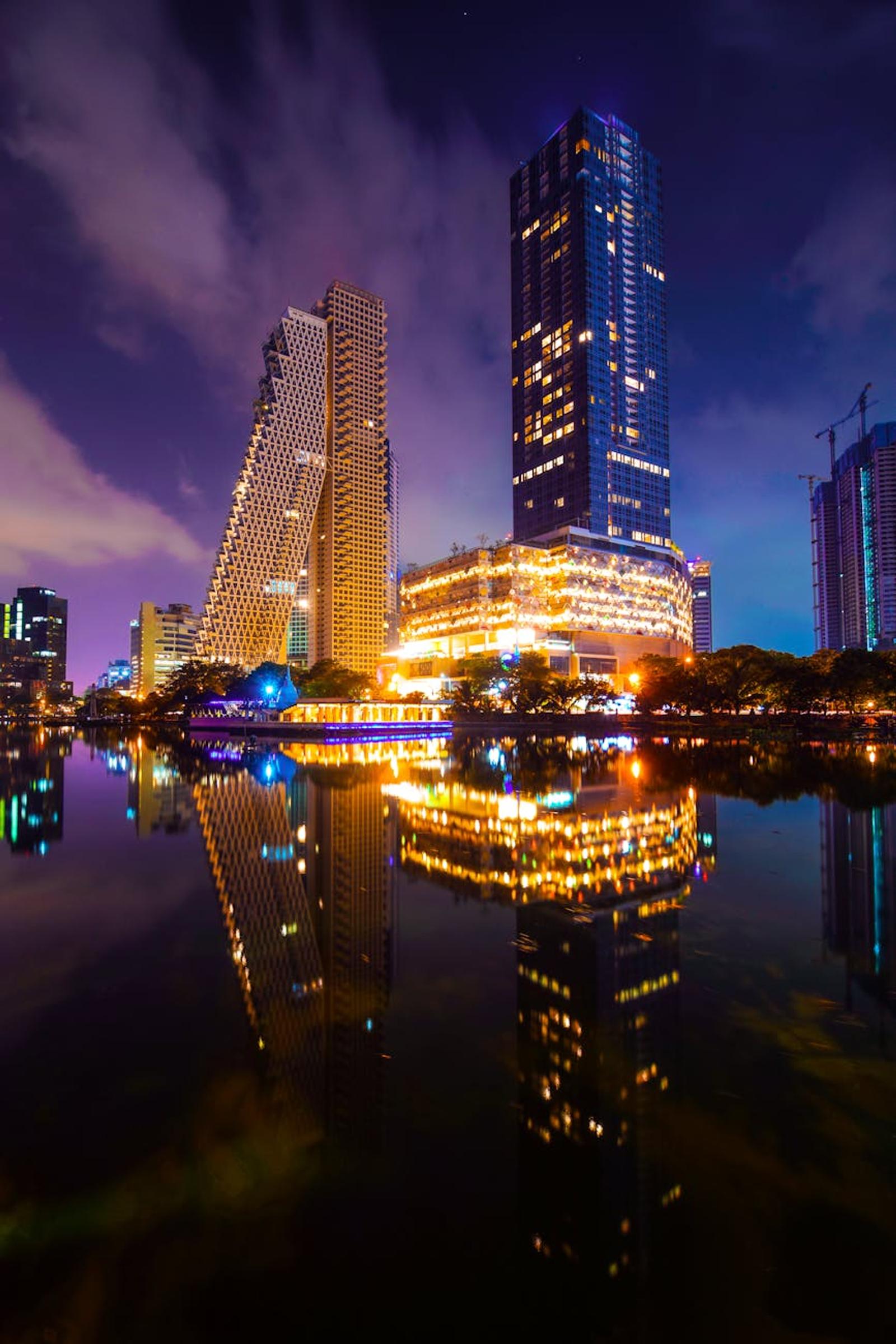 City skyline reflected in still water at night