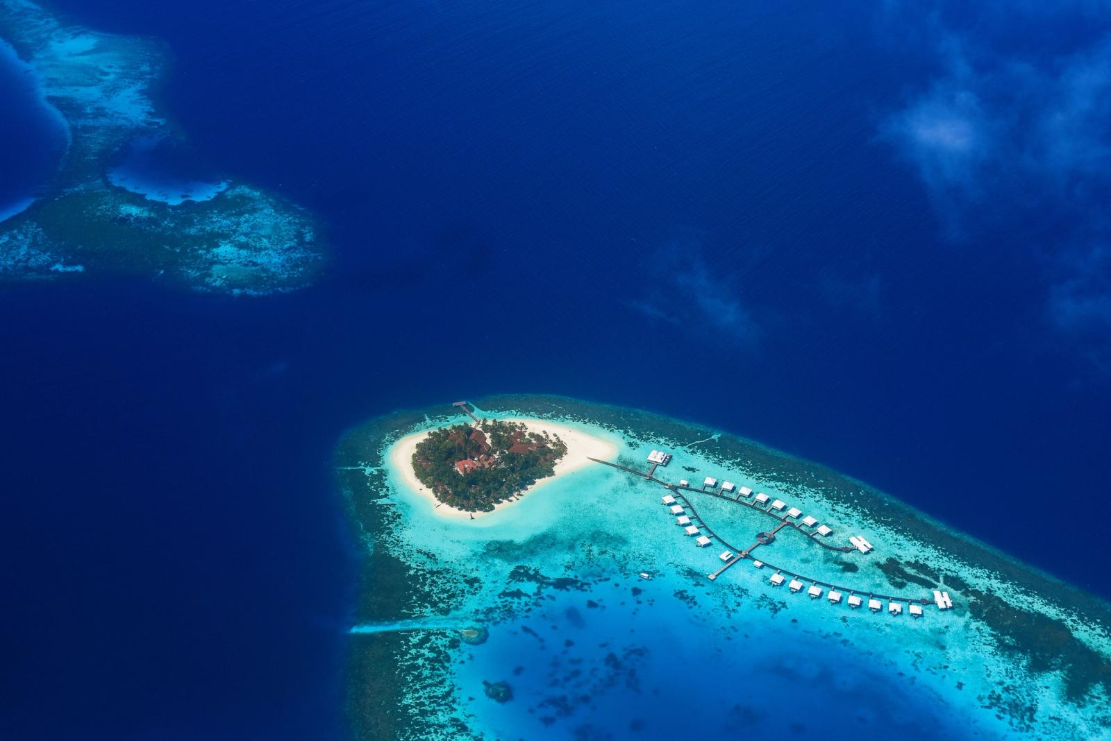 Stunning aerial shot of a tropical island paradise surrounded by turquoise waters in the Maldives