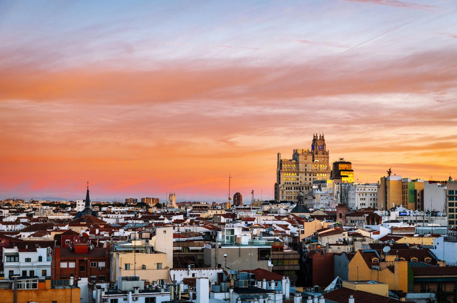 Breathtaking view of Madrid's skyline at sunset showcasing iconic architecture and vibrant sky