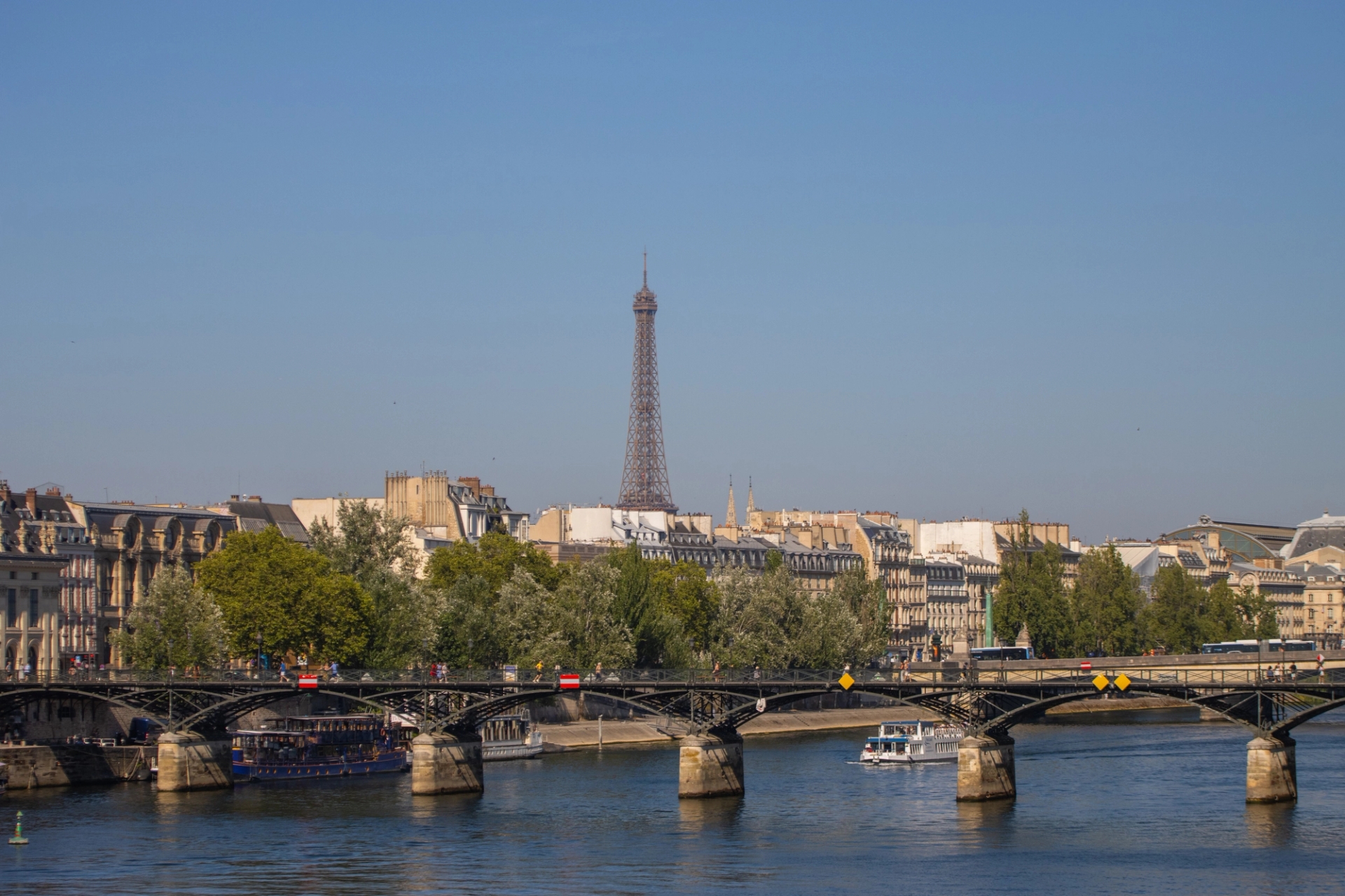 Scenic view of the Eiffel Tower and Parisian architecture from across the Seine River