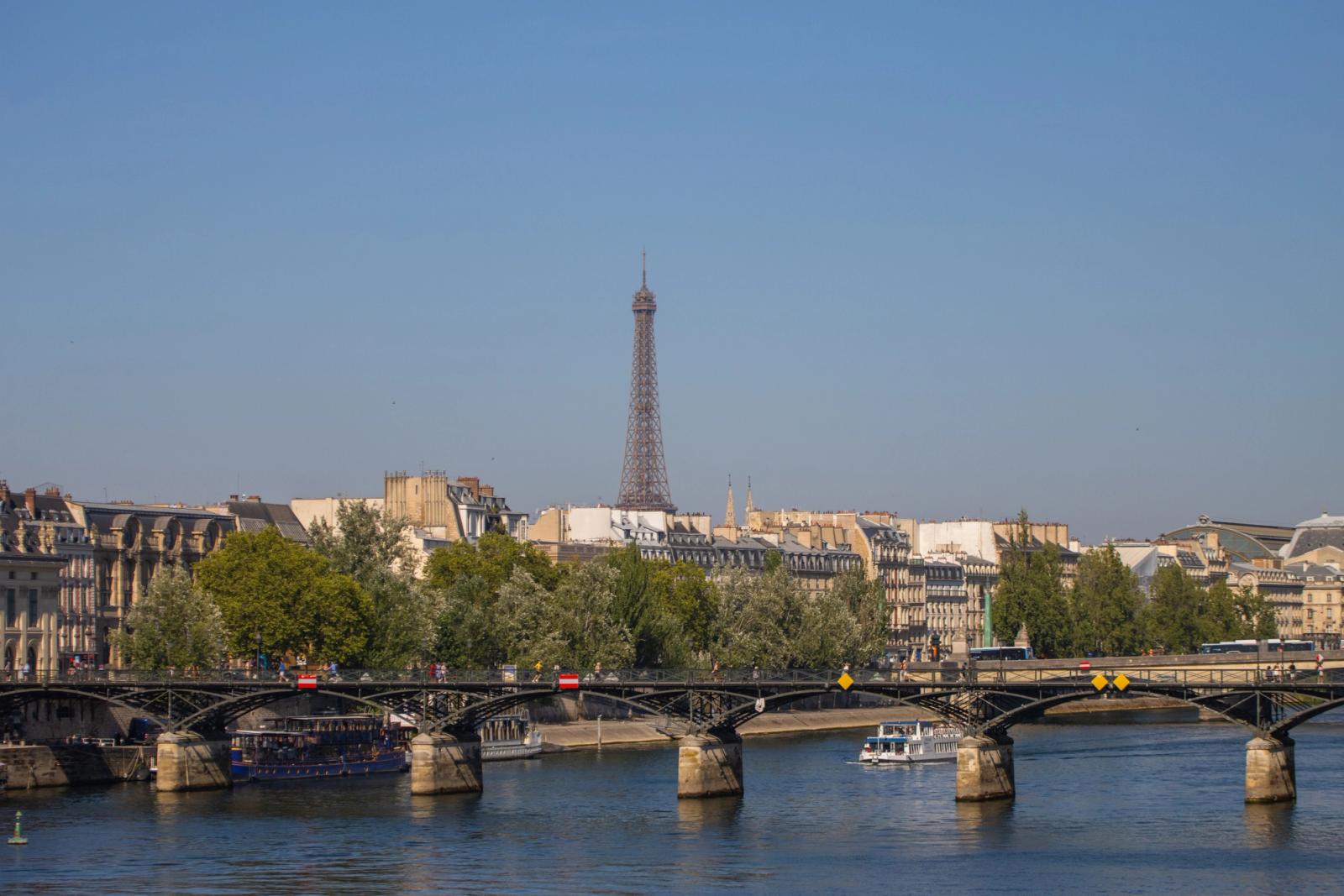 Scenic view of the Eiffel Tower and Parisian architecture from across the Seine River