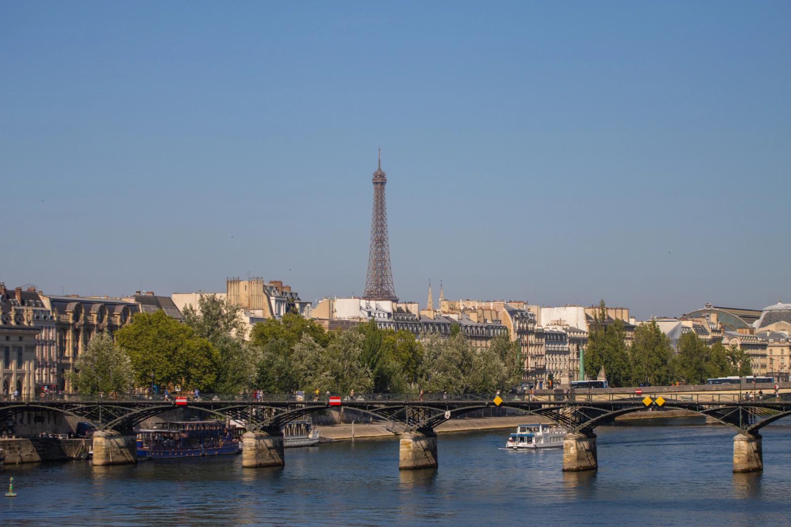 Scenic view of the Eiffel Tower and Parisian architecture from across the Seine River