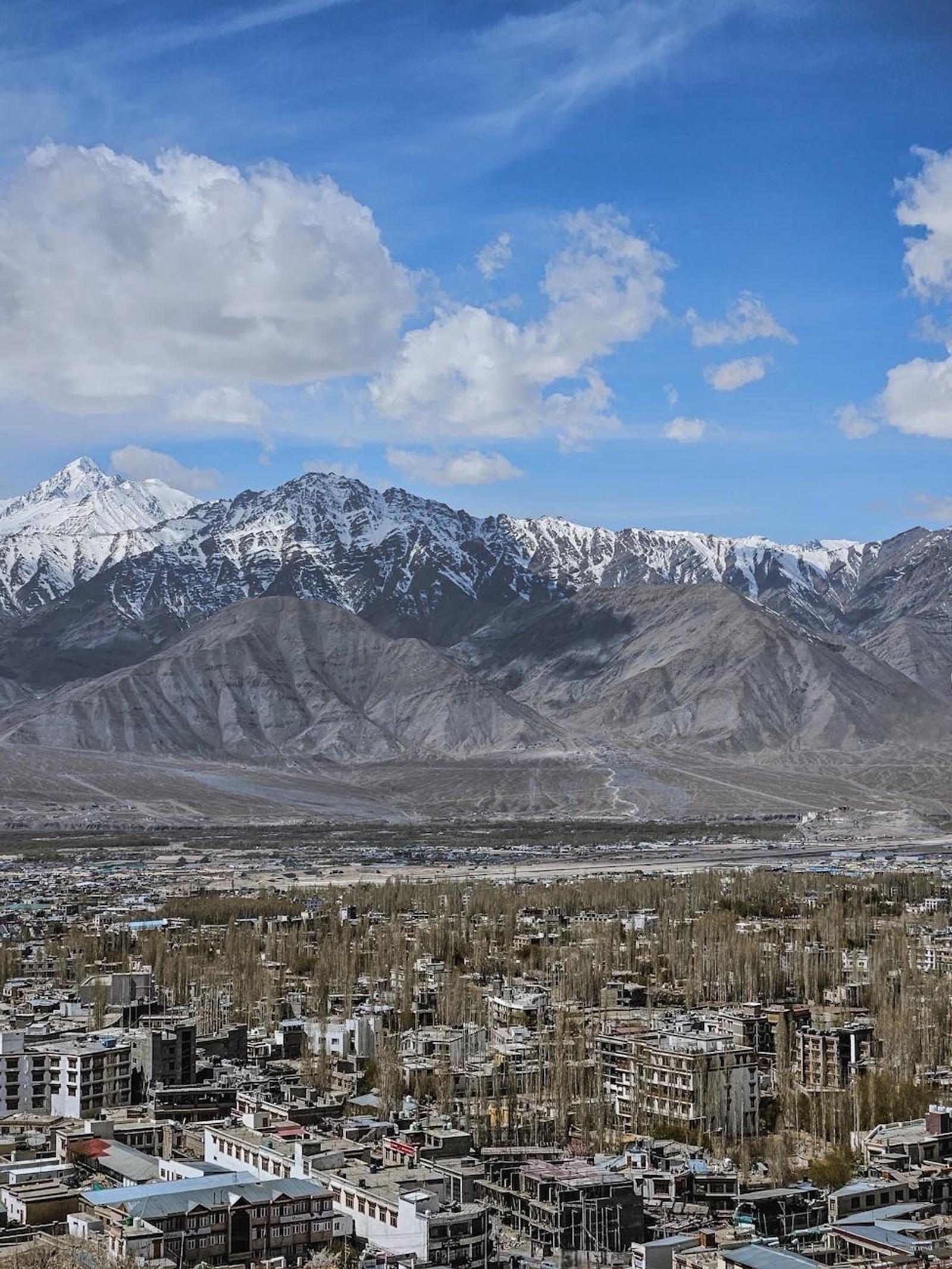 Town of poplar-lined streets nestled below a snow-capped mountain range