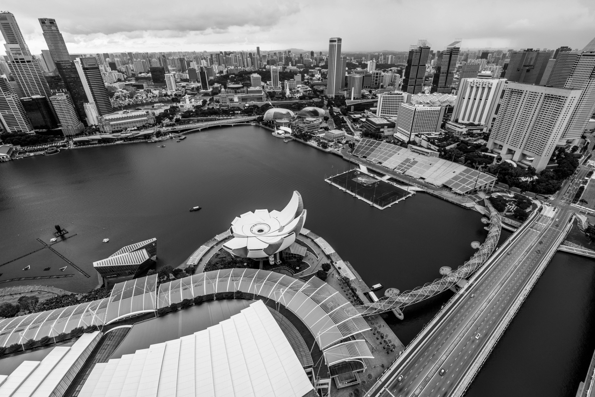 Stunning aerial view of Marina Bay area in Singapore captured in black and white, showcasing architecture and the ArtScience Museum