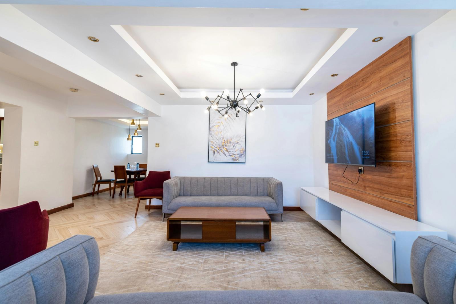 a living room with a couch and a table CySuites Apartment Hotel: Located in the heart of Westlands, Nairobi. This luxurious serviced apartment hotel boasts of modern facilities, unique services and a
