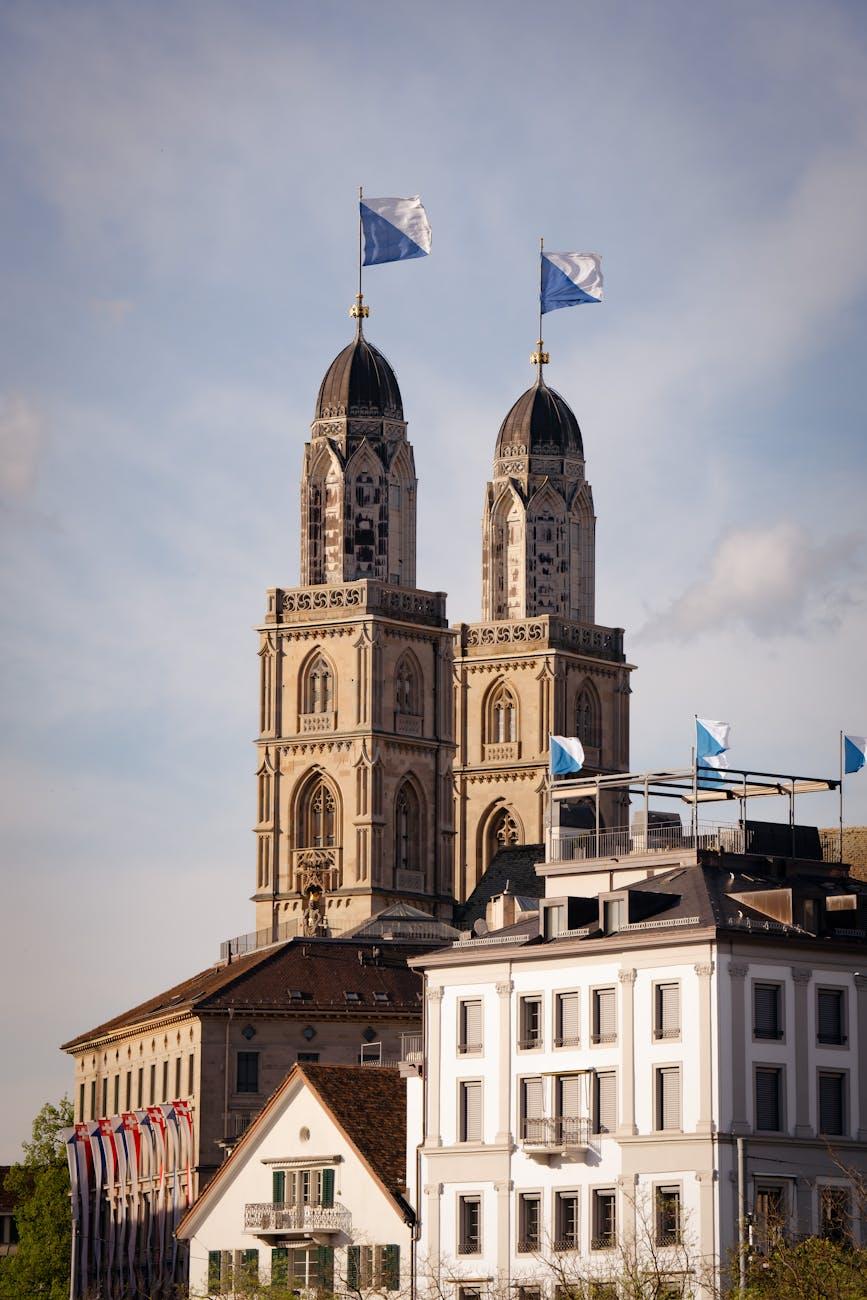 View of Grossmünster's distinct twin towers in Zurich, under a clear blue sky