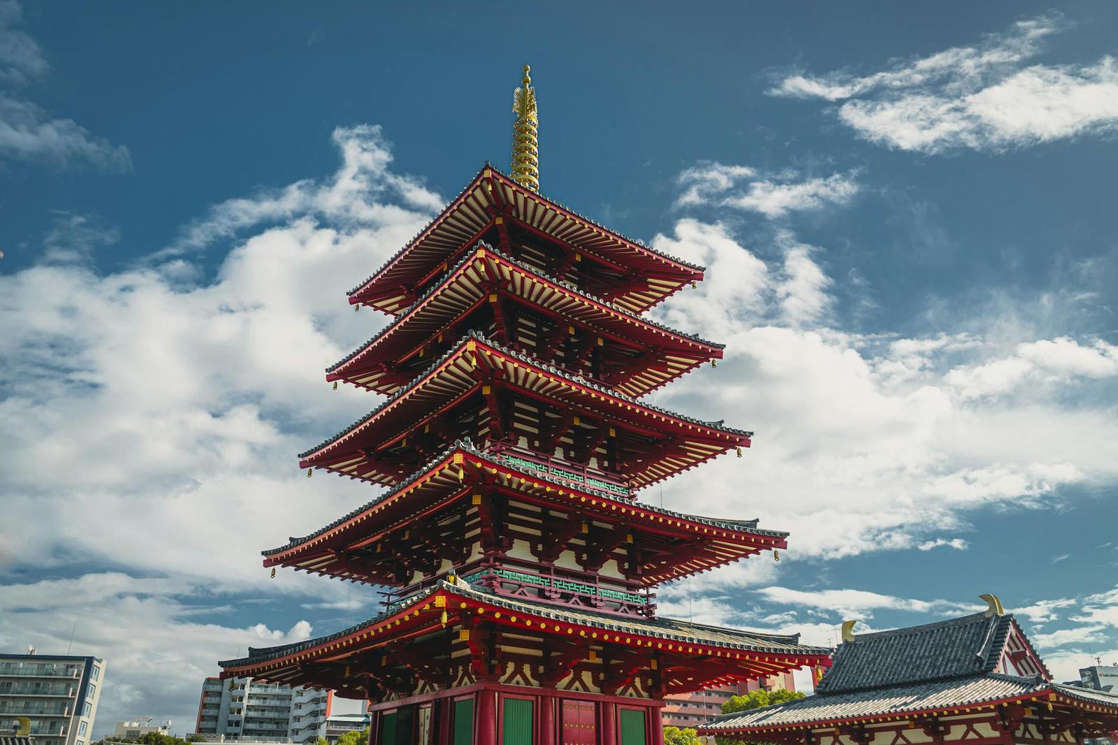 Capture the beauty of the iconic Shitennoji Temple pagoda set against a vibrant blue sky in Osaka, Japan