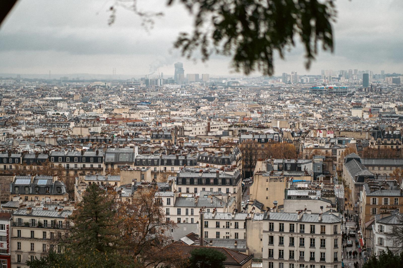 A panoramic view of Paris showcasing classic architecture on a cloudy autumn day