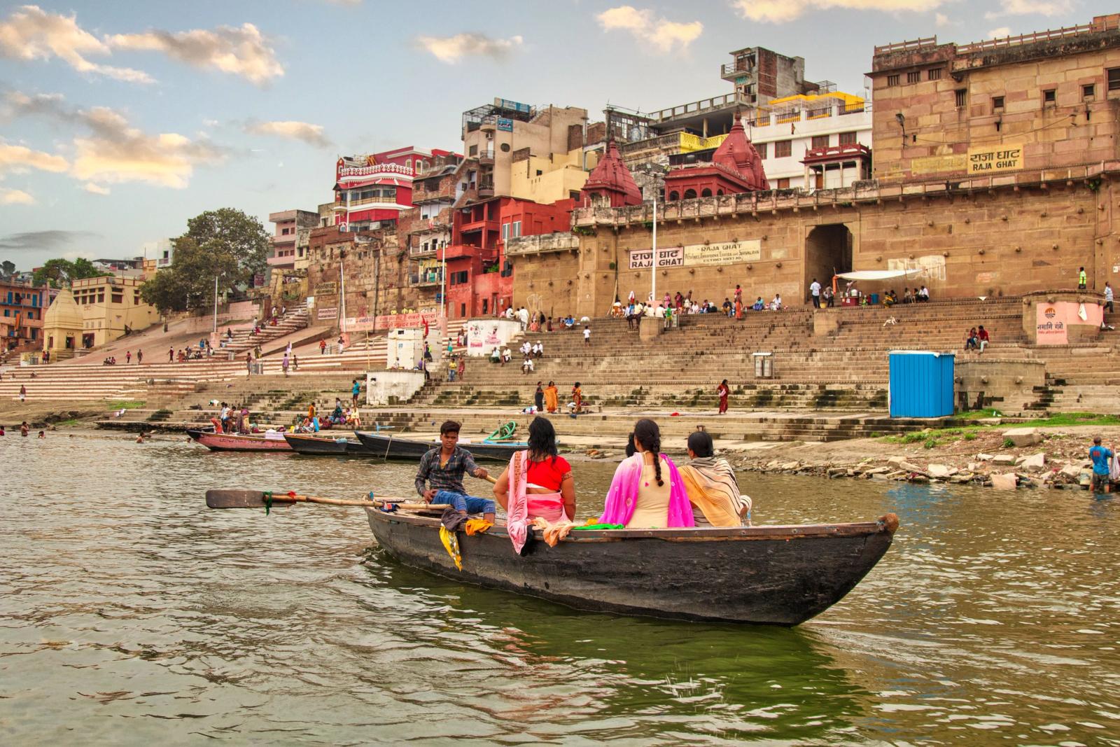 A serene boat ride along the Ganges River with a backdrop of Varanasi's historic ghats