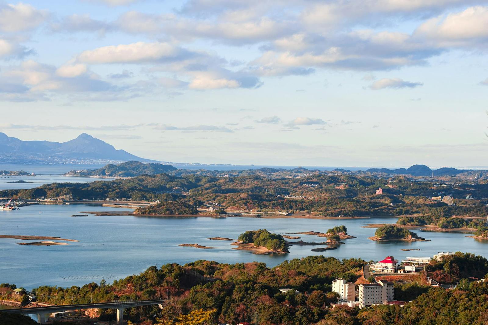 Aerial view of small forested islands scattered across a calm bay