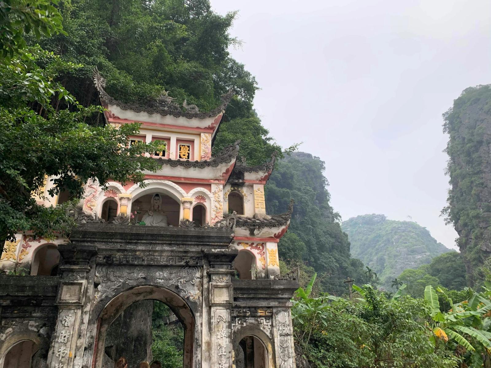 white and red temple near trees Vietnam Temple in the Forest Landscape. Green trees old architecture