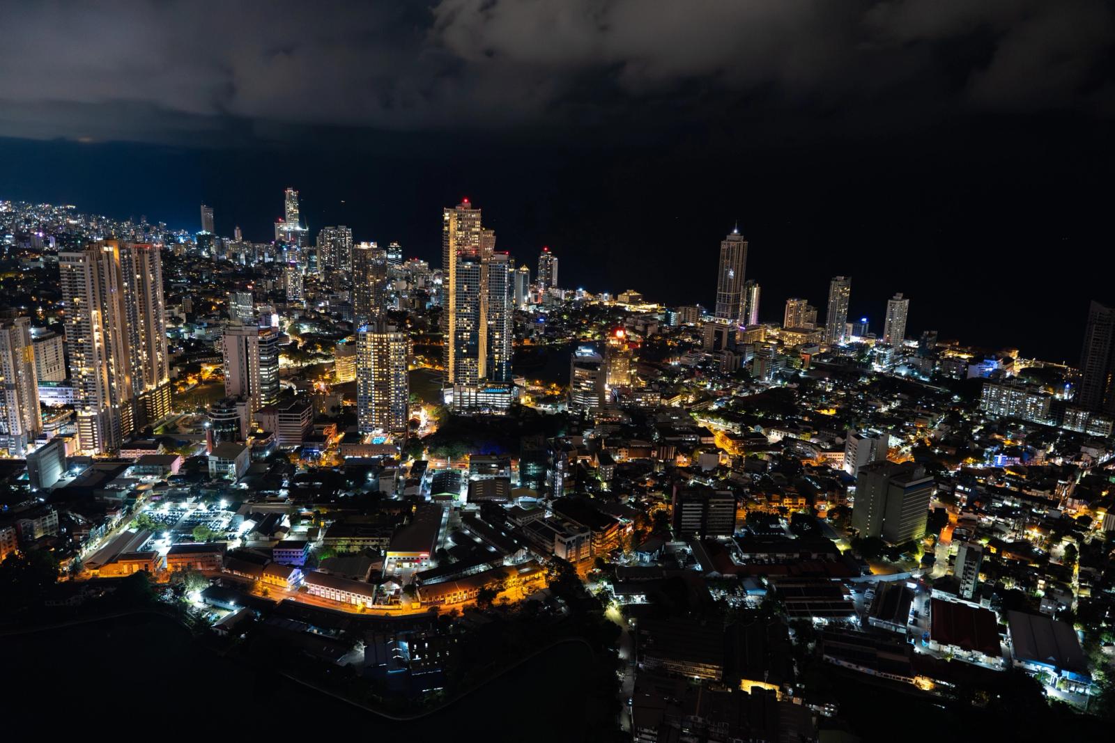 Captivating aerial view of Colombo's illuminated skyline at night, showcasing urban beauty and city lights