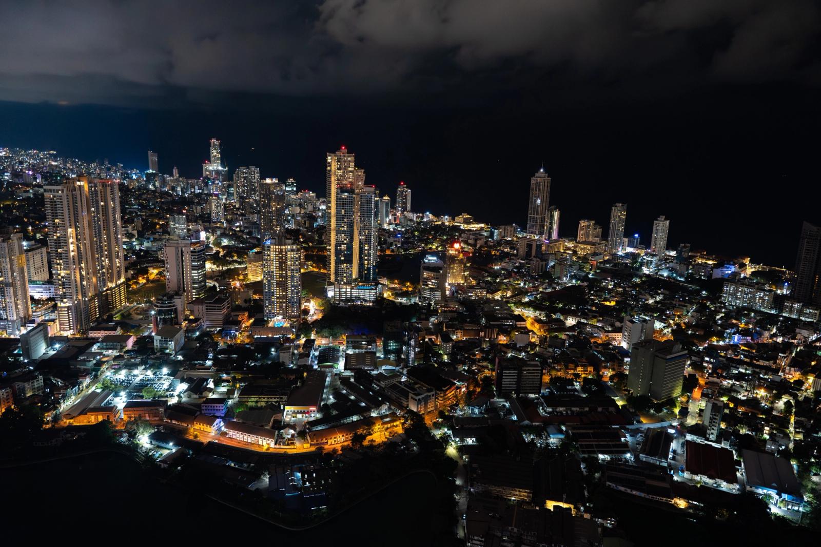 Captivating aerial view of Colombo's illuminated skyline at night, showcasing urban beauty and city lights