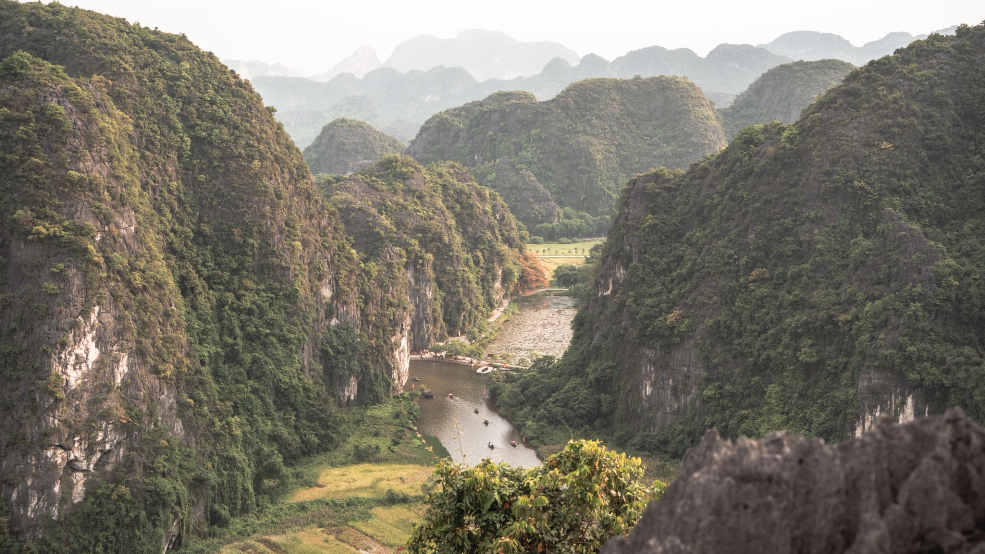 Explore the lush limestone mountains and calm river in Nam Hoa Lu, Ninh Binh, Vietnam