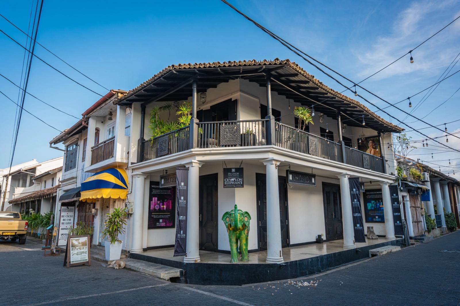 Explore the colonial charm of a street in Galle Fort, Sri Lanka, featuring vibrant architecture under a clear sky