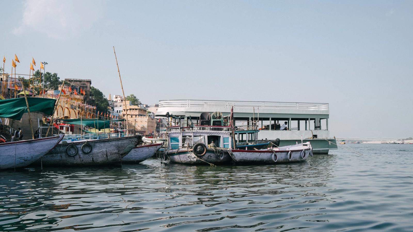 Traditional boats docked along the Ganges River in Varanasi, capturing the essence of Indian river life