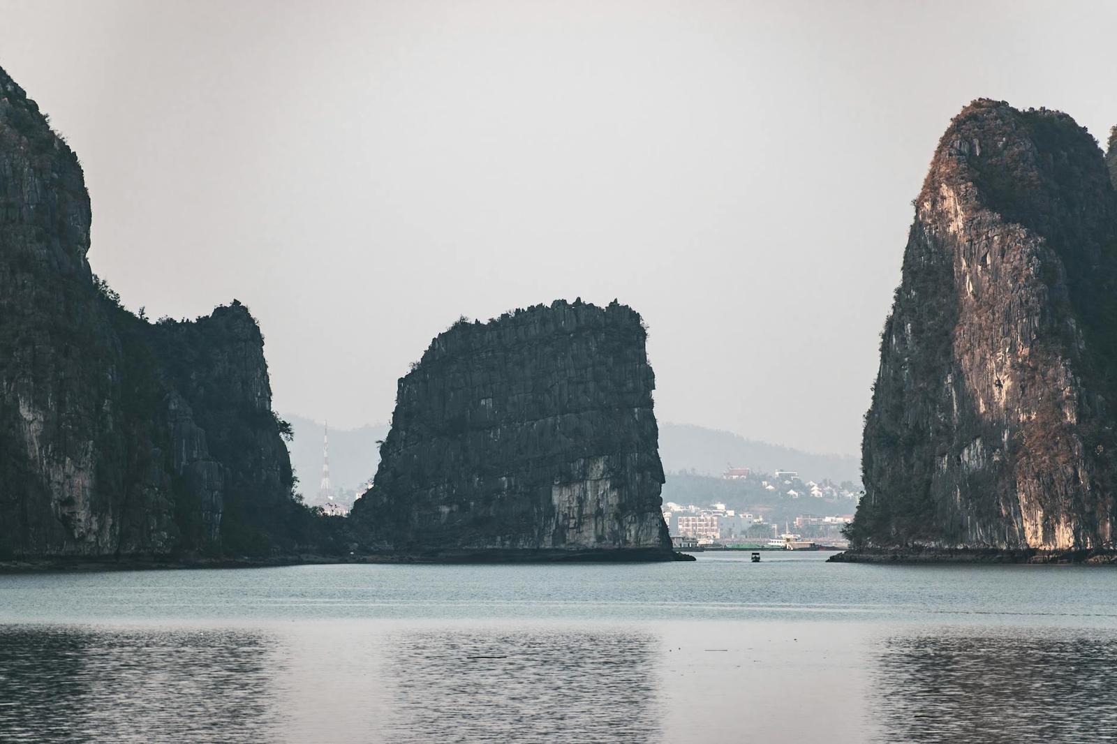Tranquil scene of Halong Bay's iconic limestone islands with calm waters, Vietnam