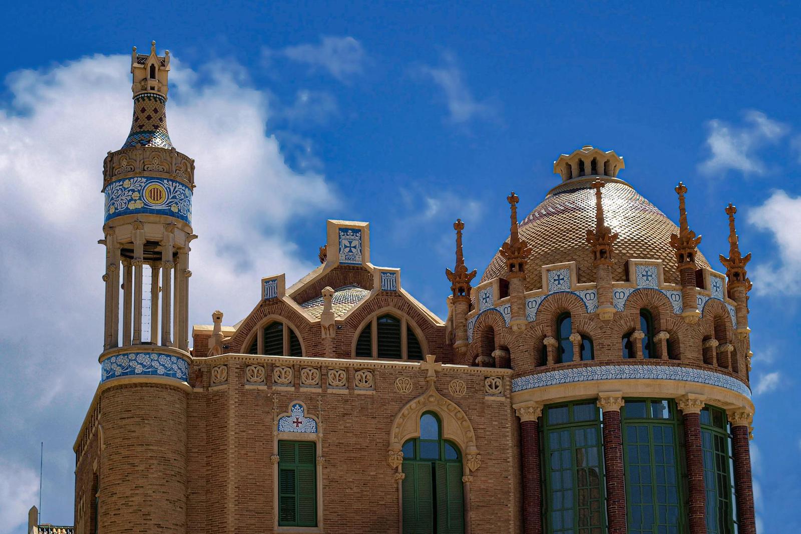 Detailed view of ornate towers and brickwork at Hospital de Sant Pau in Barcelona, Spain