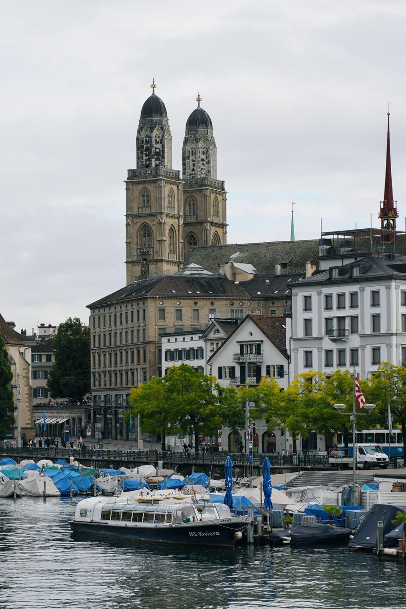 View of Grossmünster and boats on Limmat River