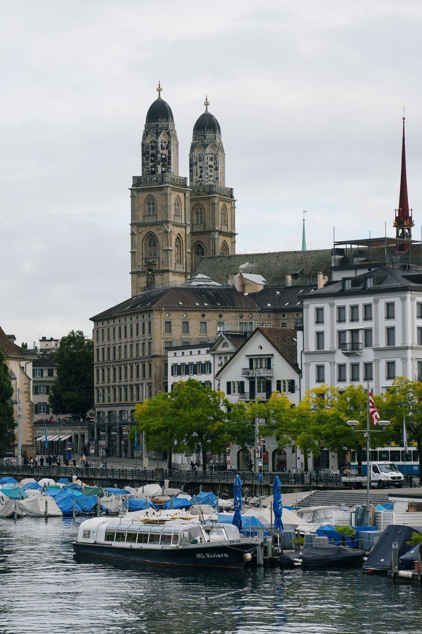 View of Grossmünster and boats on Limmat River