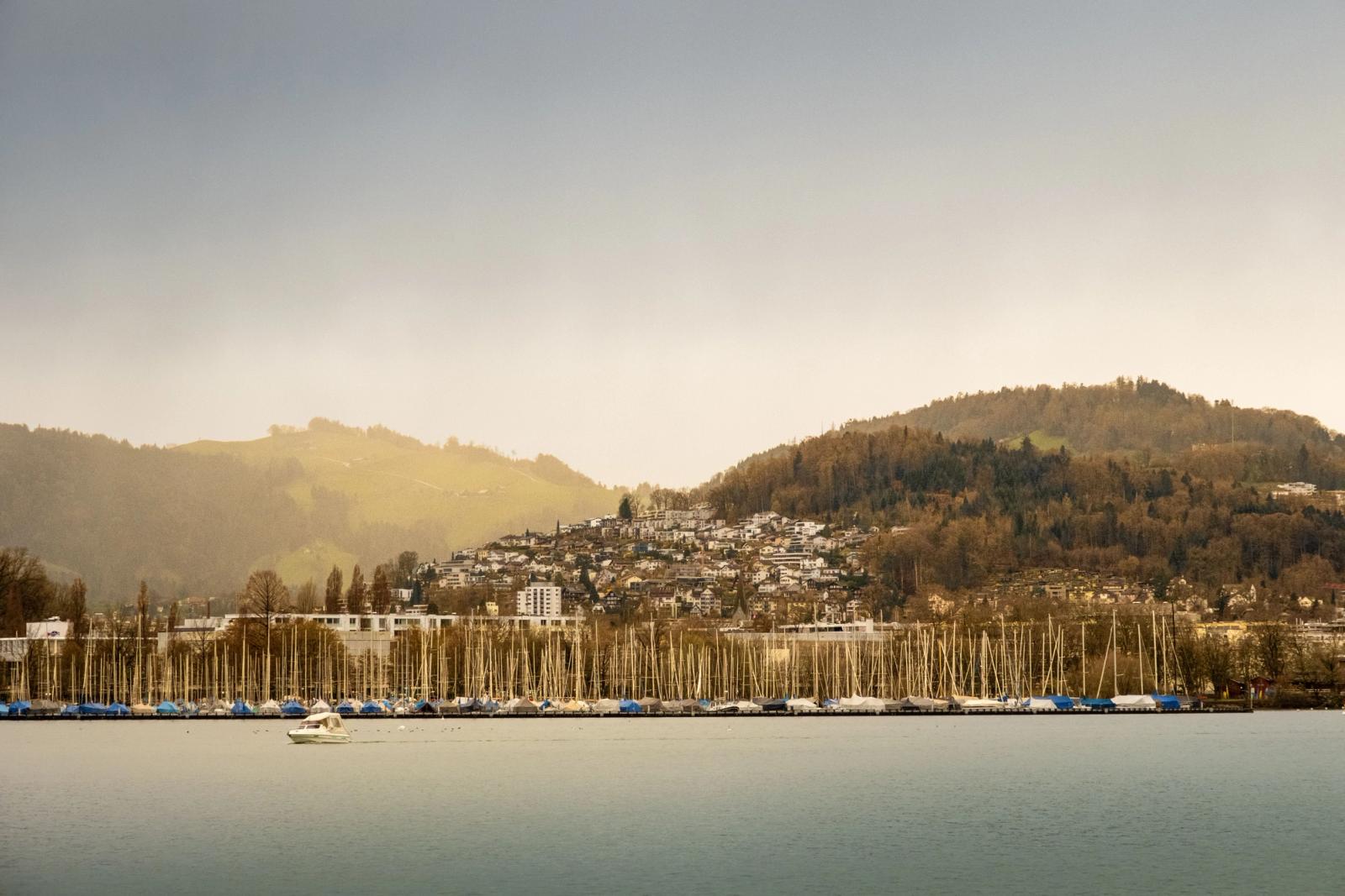 Captivating view of Lake Lucerne, Switzerland, showcasing boats docked against scenic hills