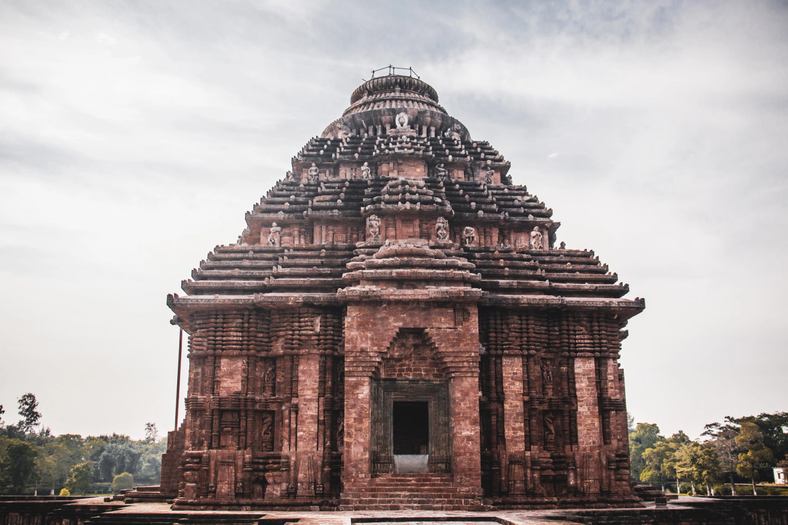 An ornately carved stone temple with a stepped pyramidal tower