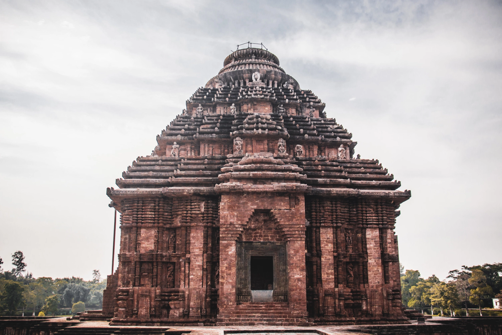 An ornately carved stone temple with a stepped pyramidal tower