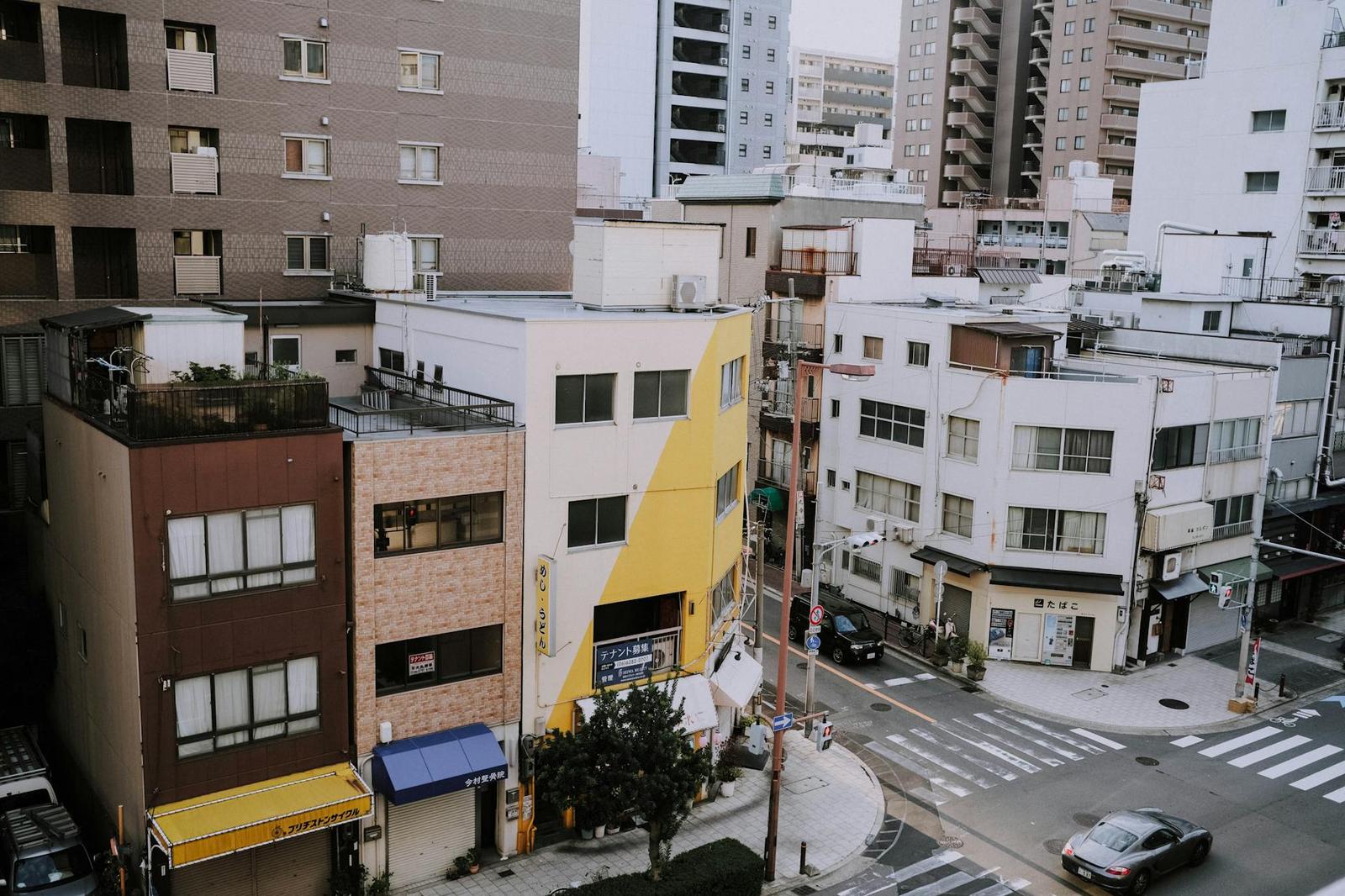 A quiet residential street corner lined with low apartment buildings