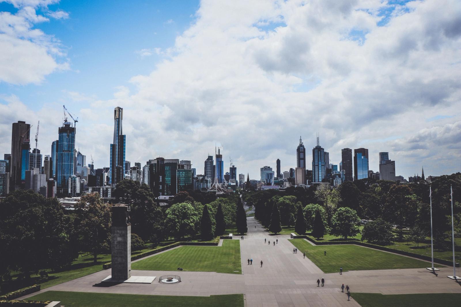 Stunning view of Melbourne skyline viewed from a park, showcasing skyscrapers and urban greenery