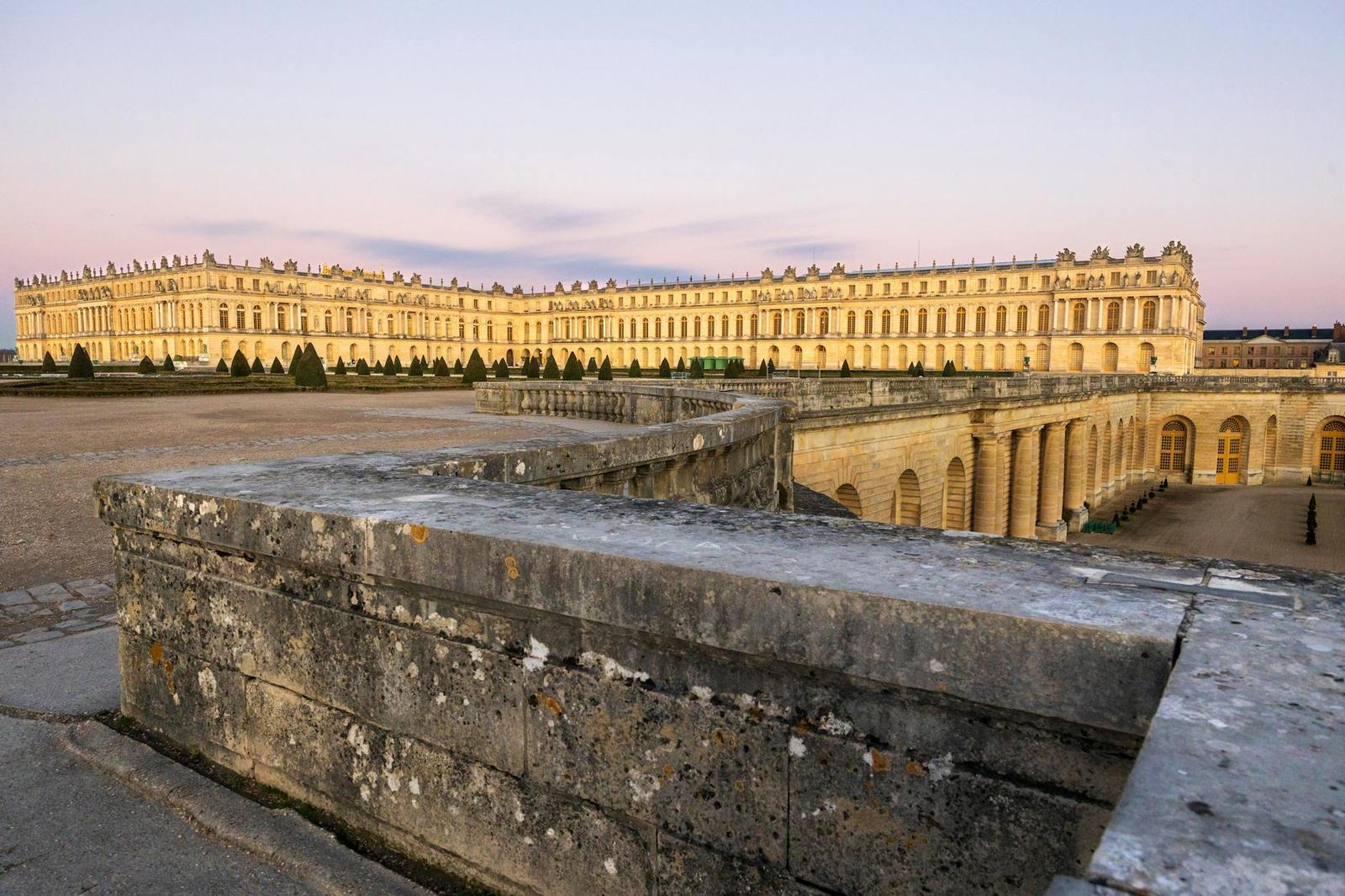 Stunning view of the Palace of Versailles at sunset