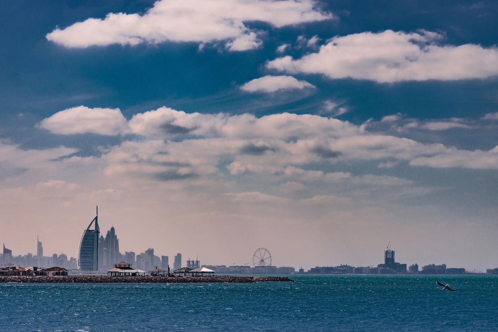 Breathtaking view of the Dubai skyline featuring Burj Al Arab with the ocean in the foreground