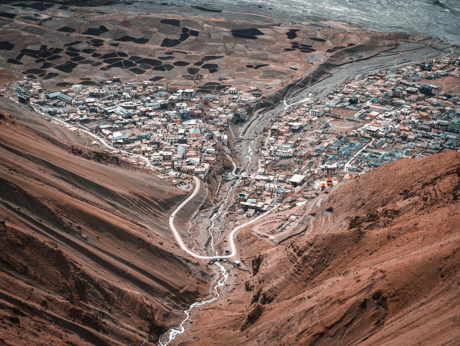 A breathtaking aerial view of the Spiti Valley, showcasing snow-capped mountains and rugged terrain